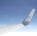 Close up of the wing tip of a modern klm airliner against a deep blue sky